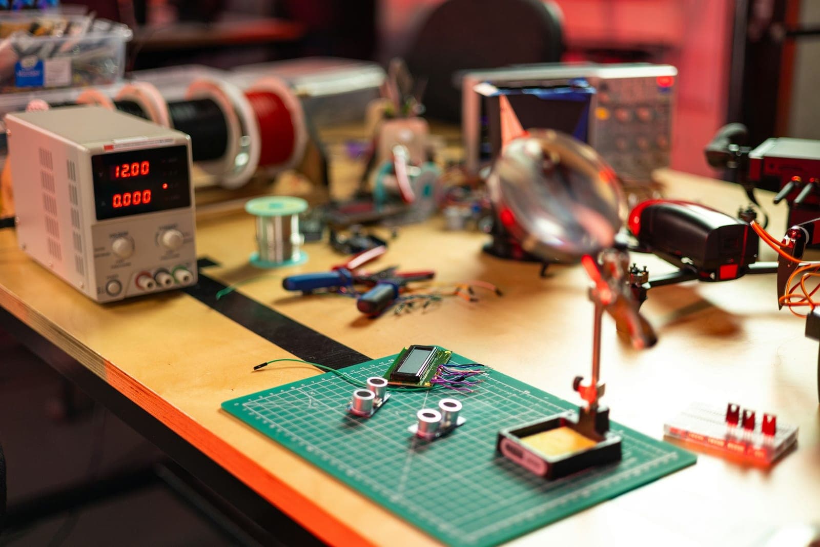 Electronics workbench with bench power supply, ultrasonic sensors, LCD module, hand tools and a drone